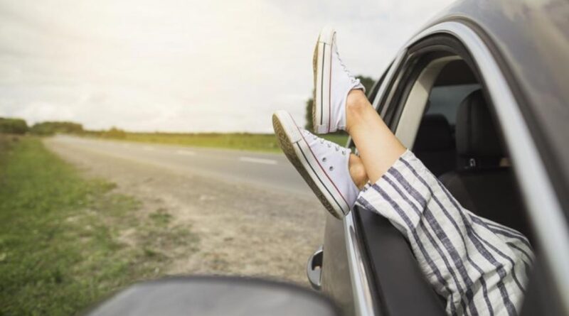 woman-s-legs-dangling-out-car-window-parked-roadside_1